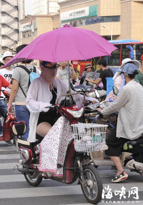 裝傘電動車在人流中穿行，傘尖易戳到人